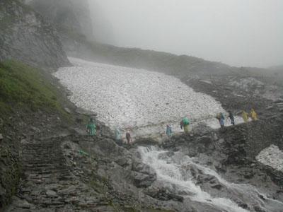 Pilgrims crossing the HemkundGlacier to reach Hemkund Sahib